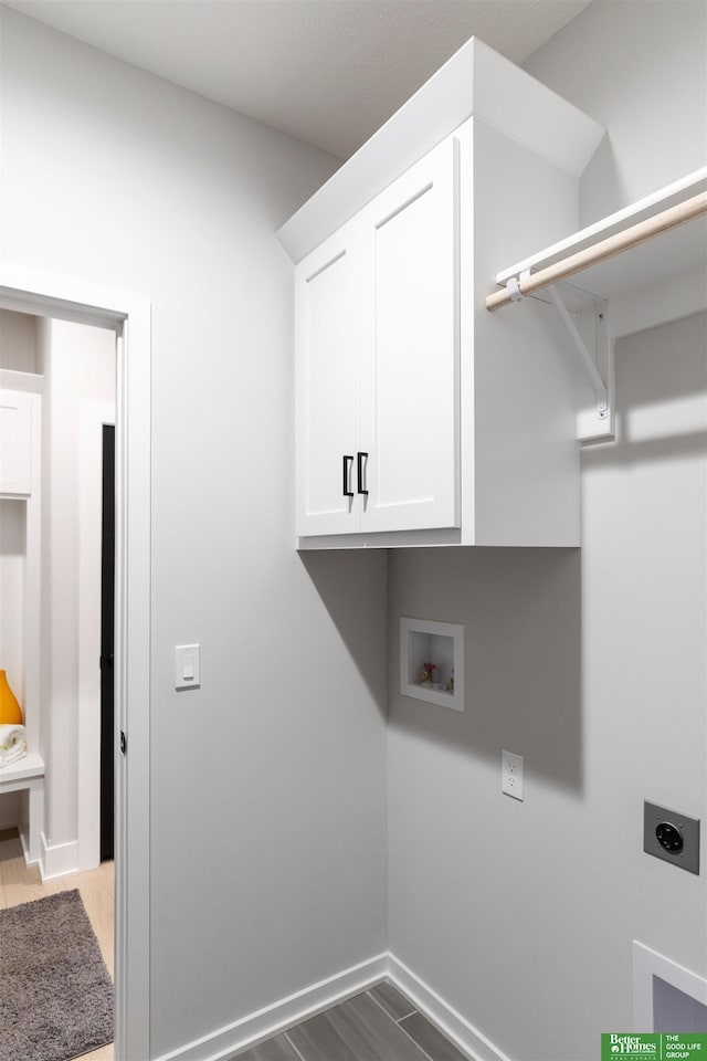 clothes washing area with cabinets, hookup for a washing machine, and hookup for an electric dryer