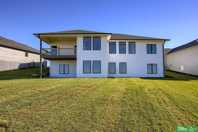 back of house featuring central AC unit, a yard, and a balcony