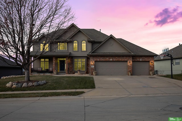 view of front facade with a garage and a yard