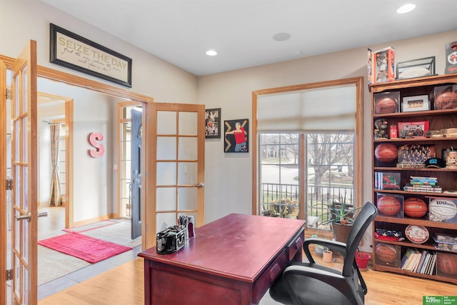 office with light wood-type flooring