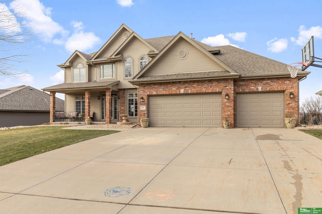 view of front of home featuring a garage, a front yard, and covered porch