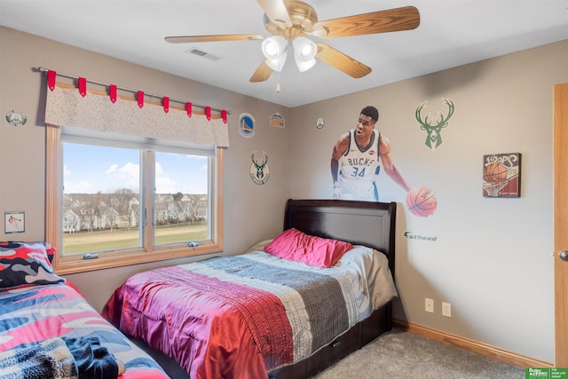 bedroom featuring ceiling fan and carpet