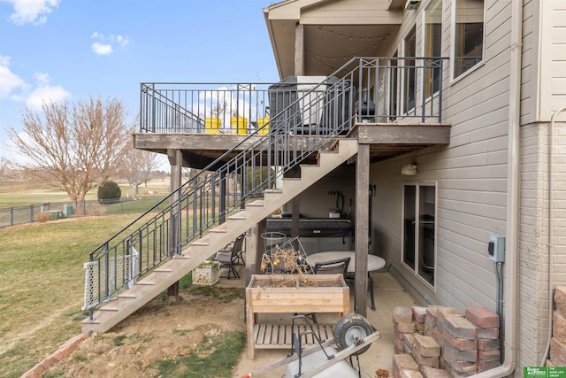 exterior space with a lawn, a hot tub, and a patio area