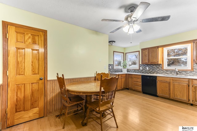 dining room with ceiling fan, sink, and light wood-type flooring