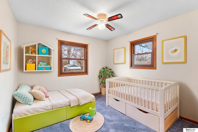 carpeted bedroom with multiple windows and ceiling fan