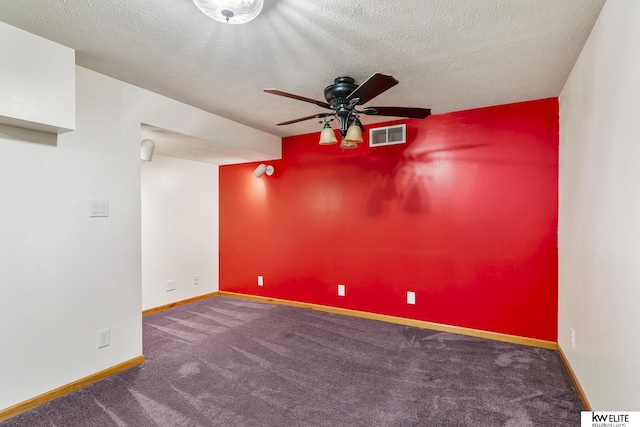 unfurnished room with ceiling fan, carpet, and a textured ceiling