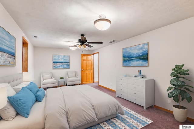 carpeted bedroom featuring a textured ceiling and ceiling fan