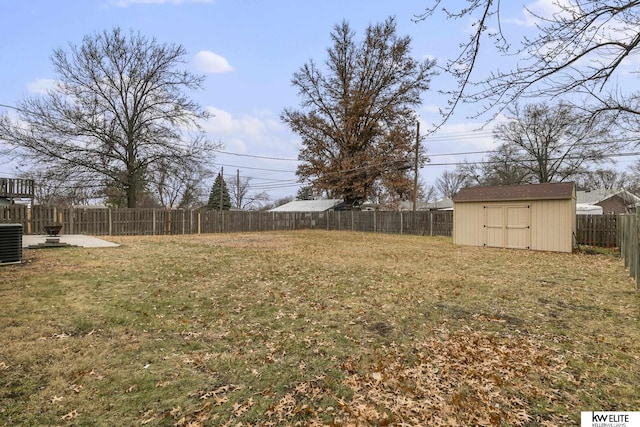 view of yard with central AC and a storage unit