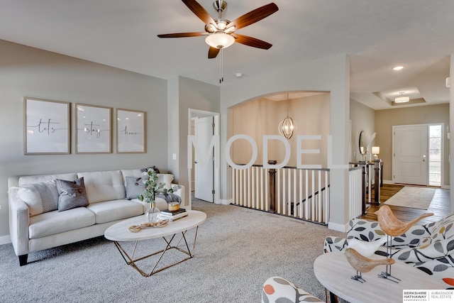 carpeted living room with a notable chandelier