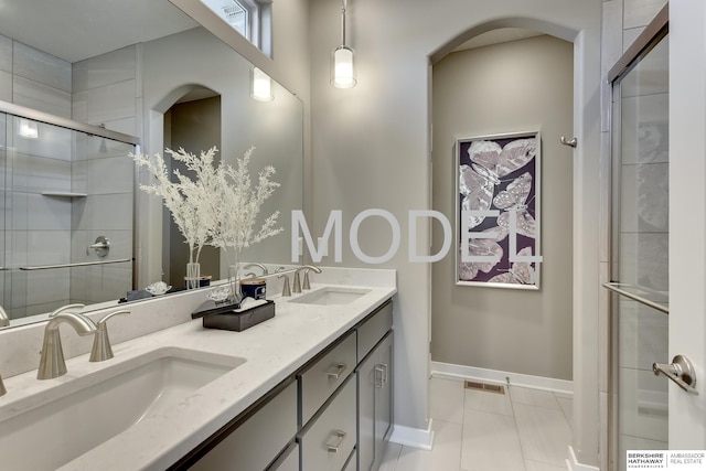 bathroom featuring tile patterned floors, an enclosed shower, and vanity