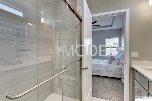 bathroom featuring a shower with door, vanity, and ceiling fan