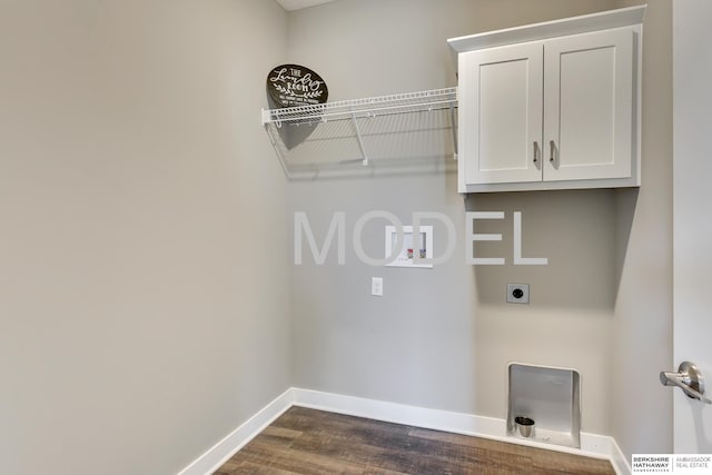 laundry room with dark wood-type flooring, cabinets, hookup for a washing machine, and electric dryer hookup