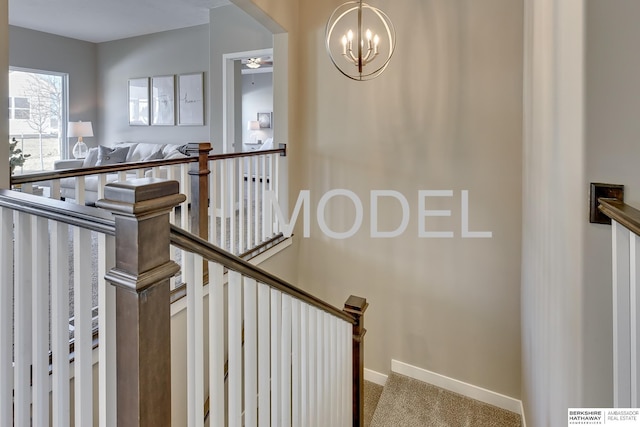 stairs featuring ceiling fan and carpet