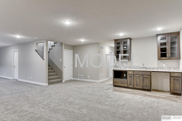 interior space with sink and light carpet