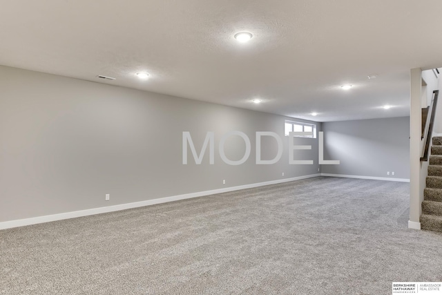 basement with a textured ceiling and carpet