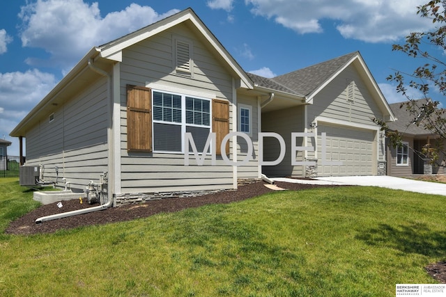 view of front of home with a garage, central AC, and a front lawn