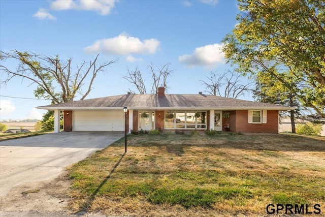 single story home with a garage and a front yard