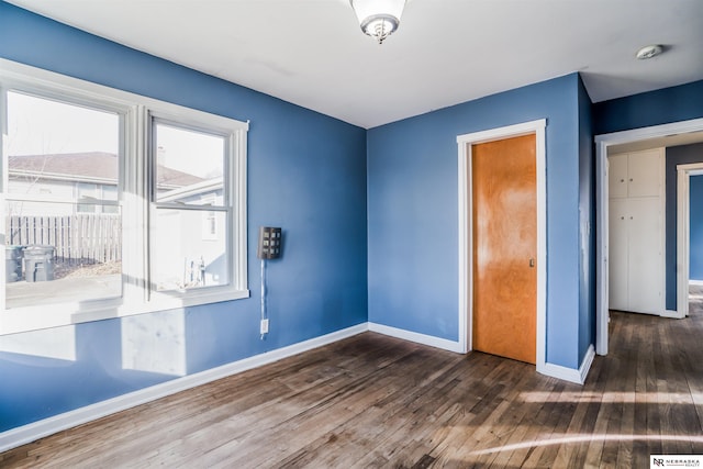 spare room with dark hardwood / wood-style floors