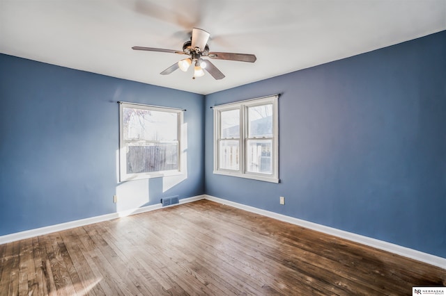 empty room featuring hardwood / wood-style flooring and ceiling fan