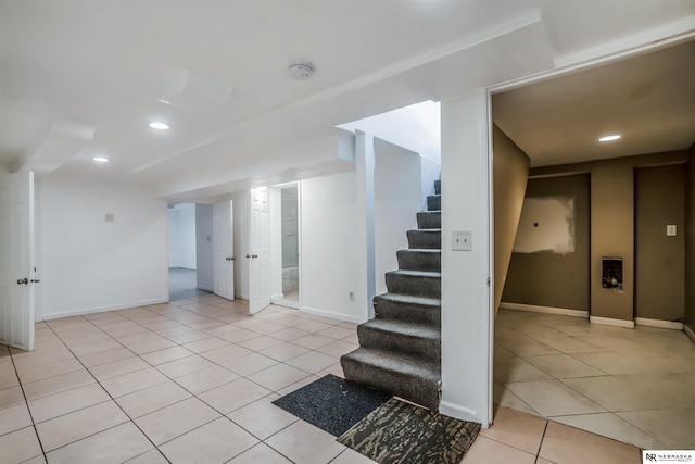 basement featuring light tile patterned floors