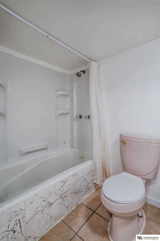 bathroom with tile patterned floors, shower / bath combination with curtain, and toilet