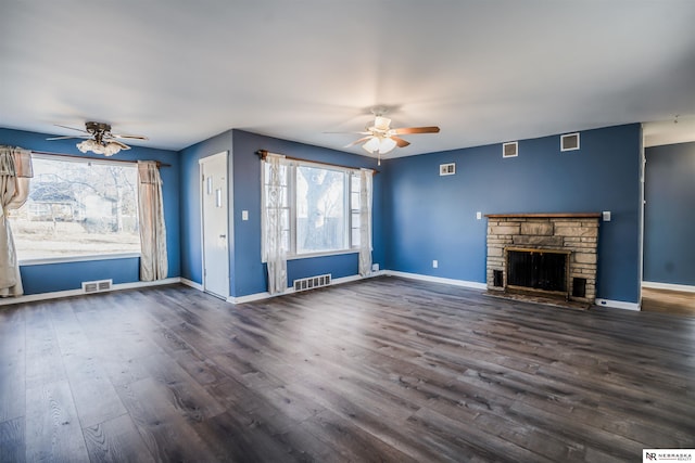 unfurnished living room featuring dark hardwood / wood-style floors, ceiling fan, and a fireplace