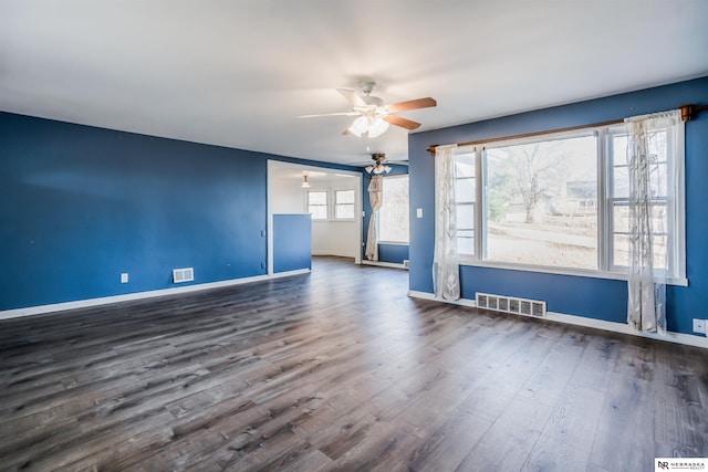 empty room with dark wood-type flooring and ceiling fan