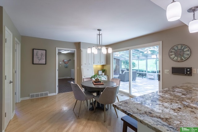 dining space featuring light wood-type flooring