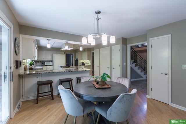 dining space with light wood-type flooring