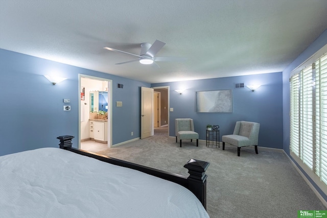 carpeted bedroom with ceiling fan, ensuite bath, and a textured ceiling