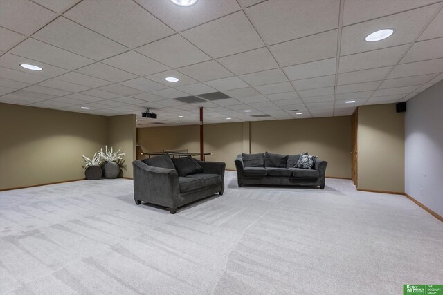 living room featuring light colored carpet and a drop ceiling