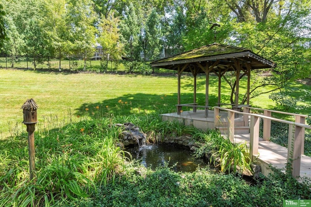 view of yard featuring a gazebo and a water view