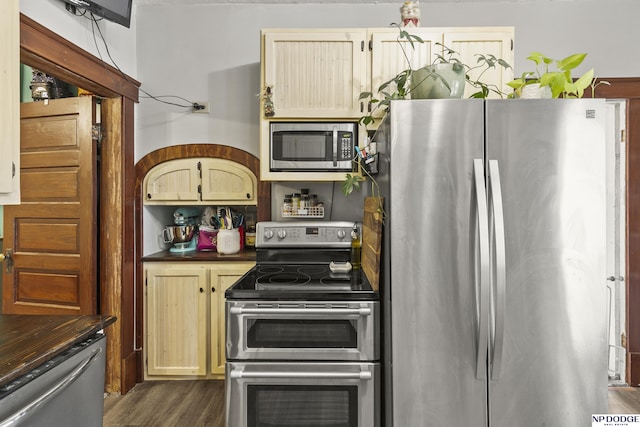 kitchen with appliances with stainless steel finishes, dark wood-type flooring, and light brown cabinets