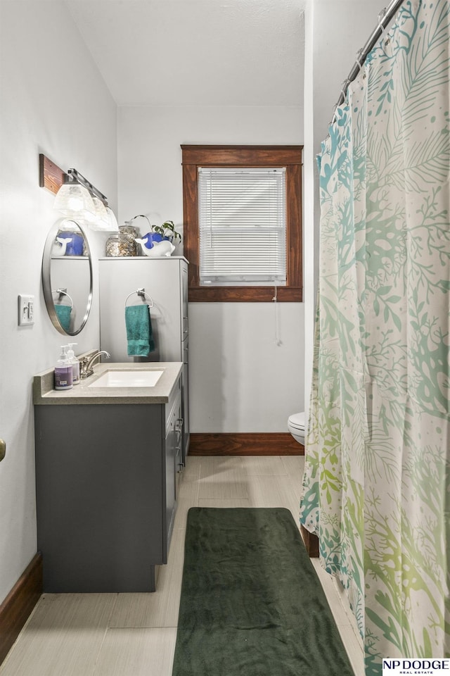 bathroom featuring vanity and toilet