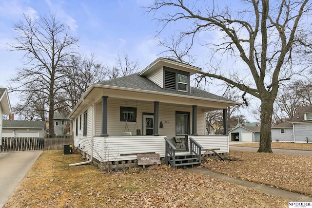 bungalow-style house with central AC and a porch