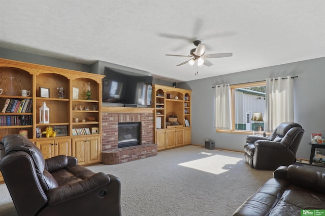 living room featuring ceiling fan, light colored carpet, a brick fireplace, and a textured ceiling