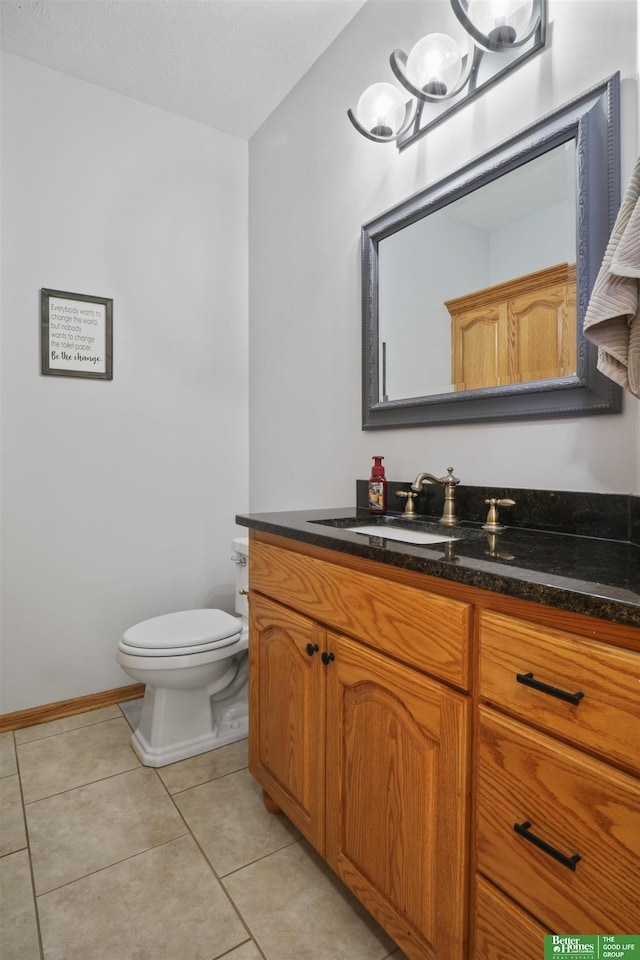 bathroom featuring vanity, tile patterned floors, and toilet