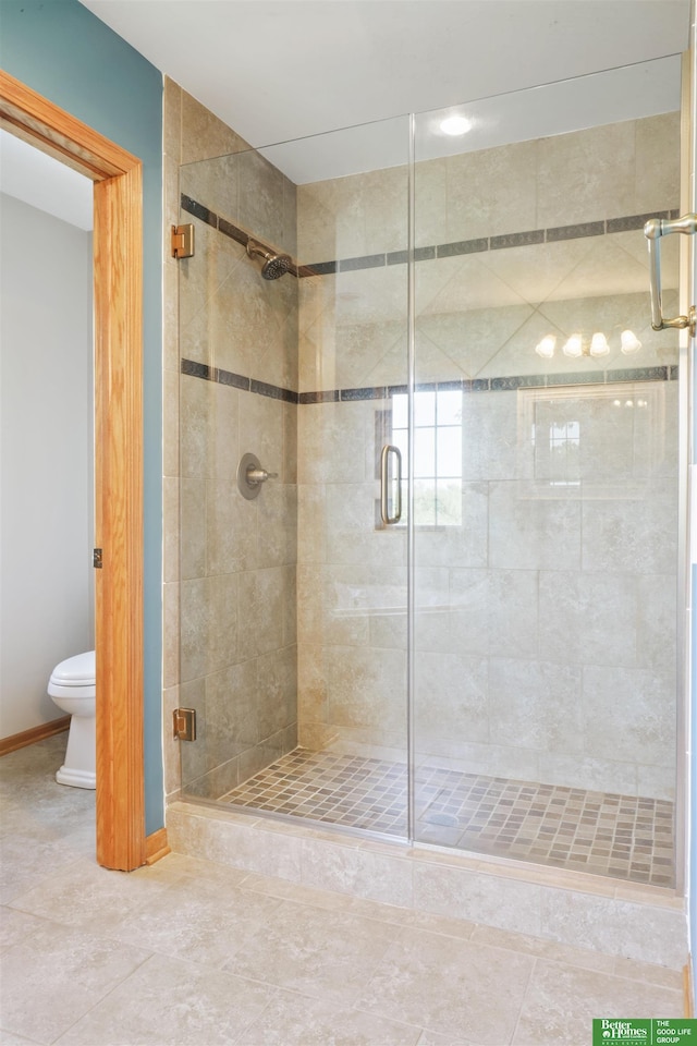 bathroom featuring an enclosed shower and toilet