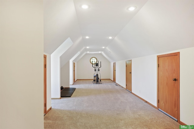 bonus room featuring lofted ceiling and light carpet