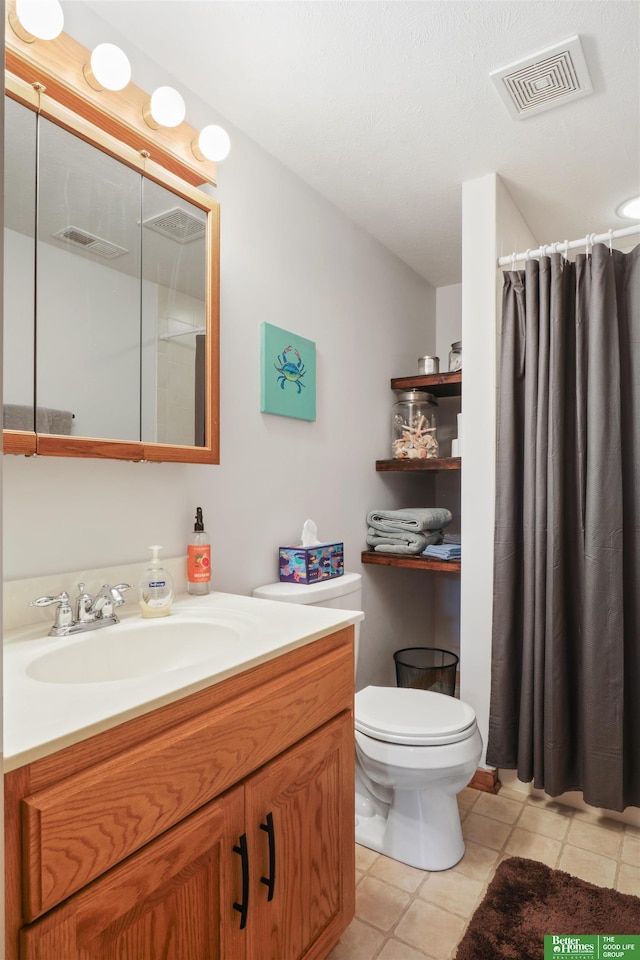 bathroom featuring vanity, a shower with curtain, tile patterned floors, and toilet