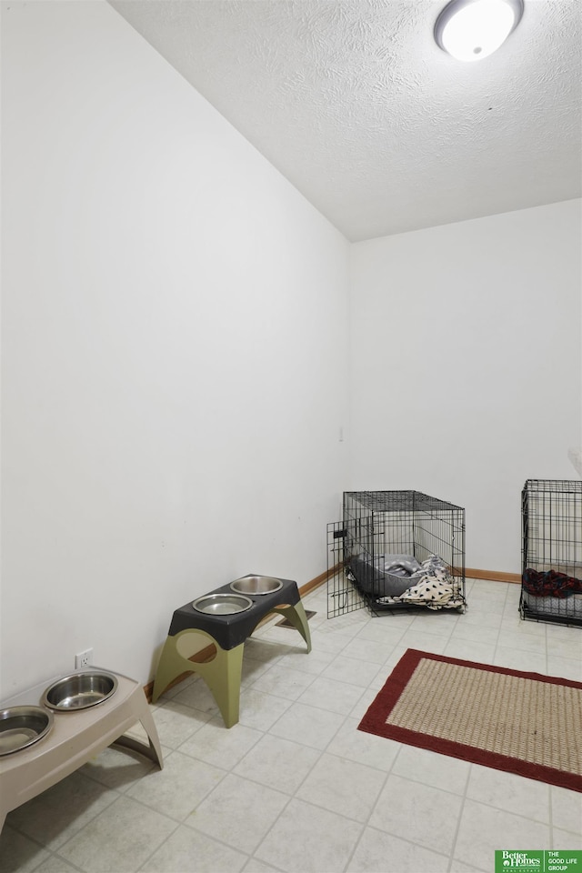 living area featuring light tile patterned floors and a textured ceiling