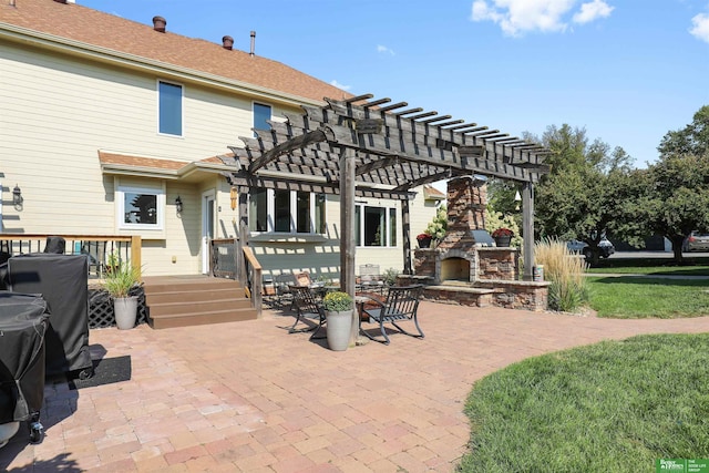 back of house featuring a pergola, a patio, and an outdoor stone fireplace