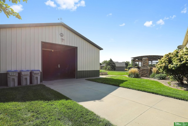 view of outbuilding featuring a lawn