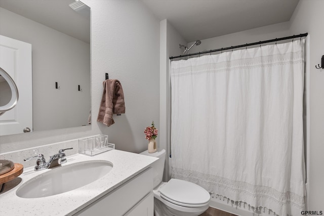 bathroom with vanity, toilet, and walk in shower