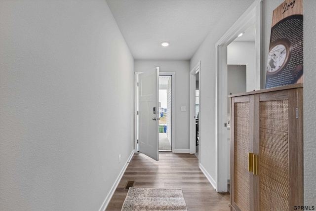 hallway featuring wood-type flooring