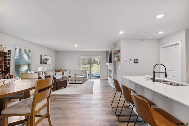 dining room featuring sink, dark wood-type flooring, and plenty of natural light