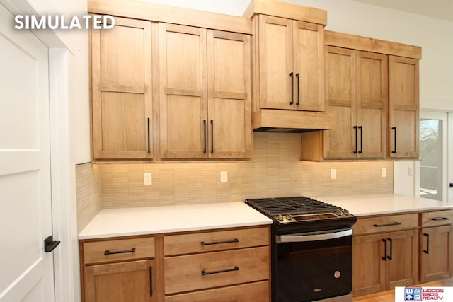 kitchen featuring backsplash and stainless steel gas range oven