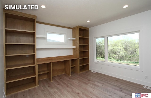 unfurnished office featuring hardwood / wood-style floors