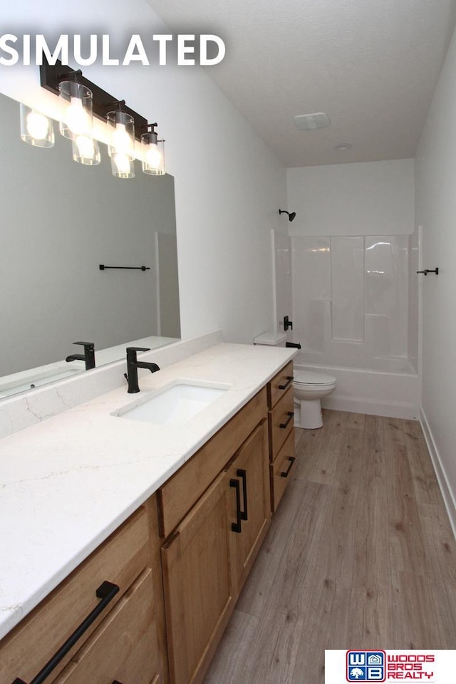 full bathroom with vanity, hardwood / wood-style floors, shower / bathtub combination, and toilet