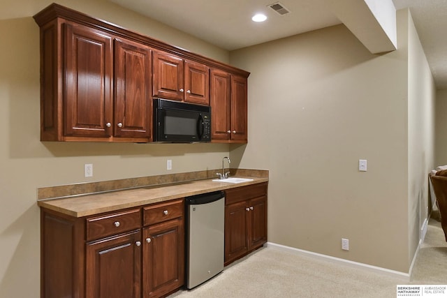 kitchen with sink, light colored carpet, and dishwasher